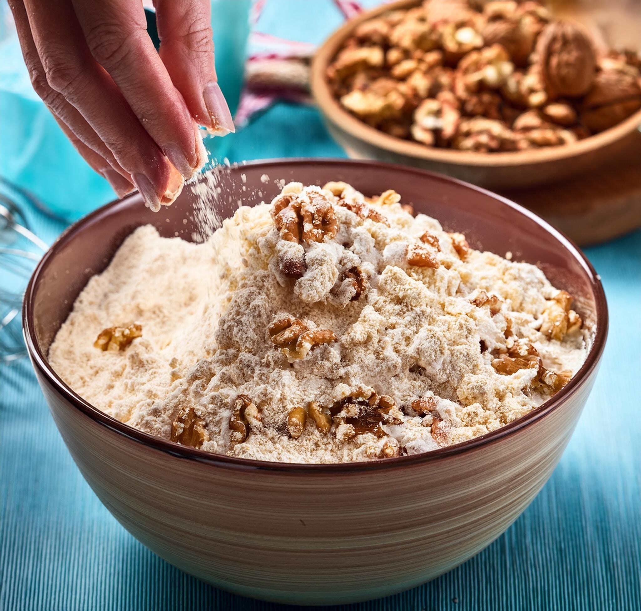 Classic Banana Bread Recipe A photo showing the dry and wet ingredients being gently combined, with chopped walnuts being folded in
