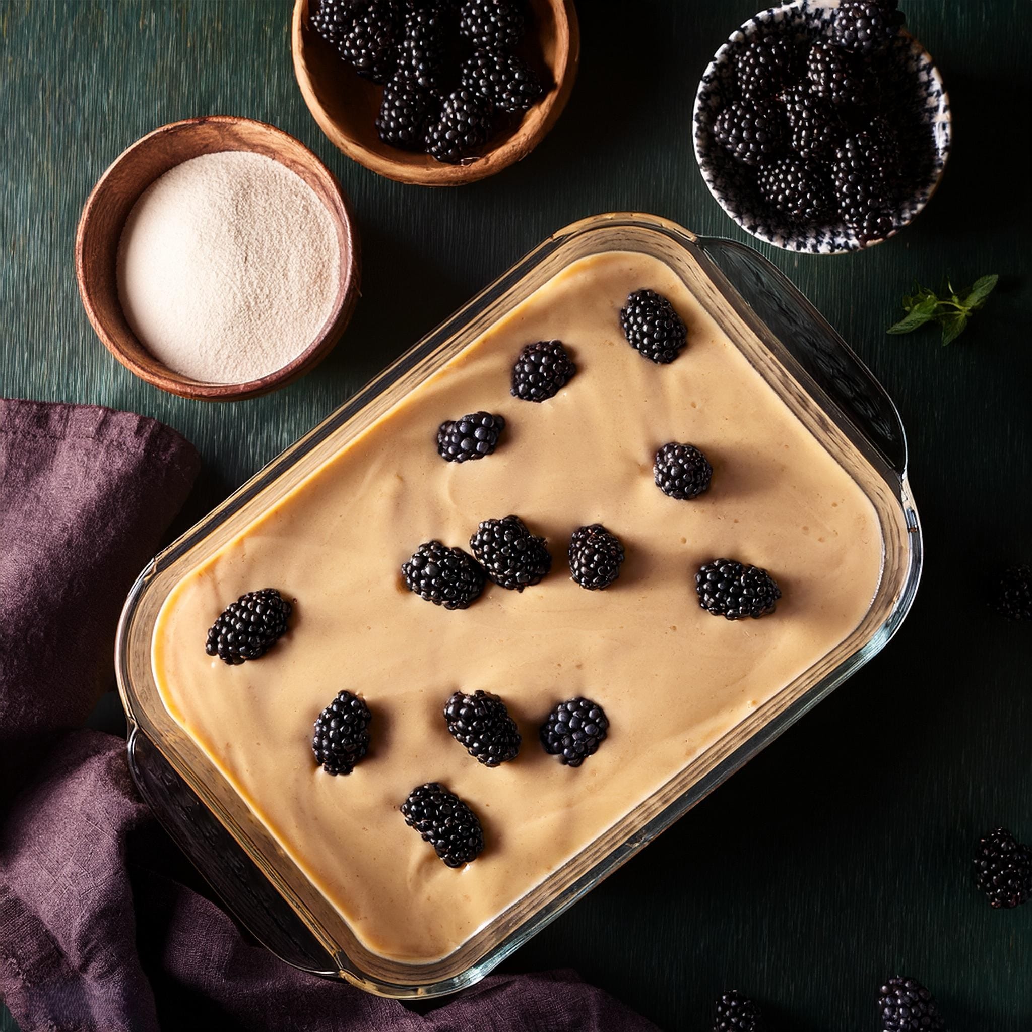 Baking Mix Blackberry Cobbler Recipe A photo showing the smooth batter being poured into a greased baking dish, followed by blackberries being evenly scattered on top